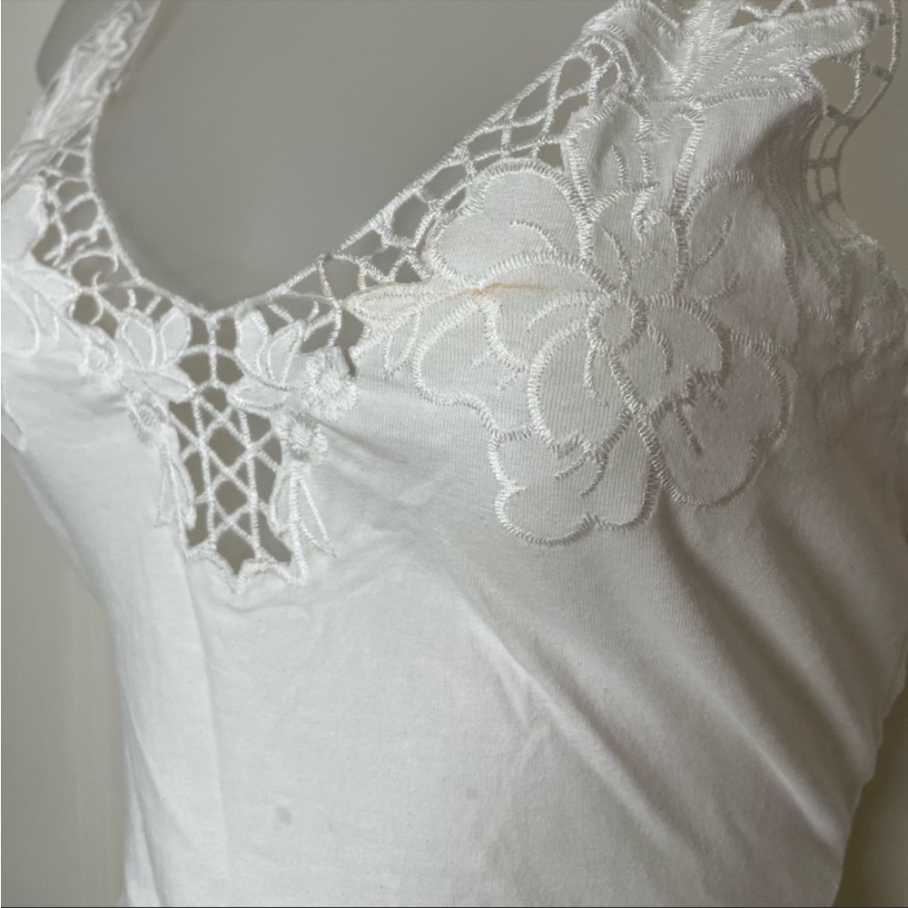 White bodysuit with snap closures and adjustable straps